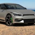 Style Kills—China Slams Car Door Gimmicks Silver electric hatchback parked on a sandy coastal road