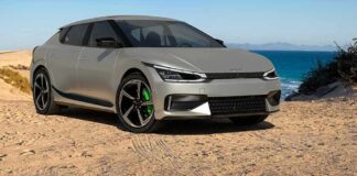 Silver electric hatchback parked on a sandy coastal road