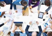 Leadership Stipends – For Immigrants Only Group of professionals collaborating around a conference table