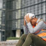 HR Warnings Ignored — Worker Ends Up Dead construction worker sitting with head in hands