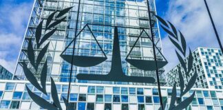Scales of justice emblem on glass facade of modern office building
