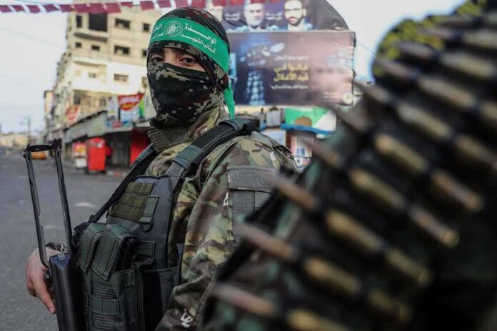 armed person in camouflage and face covering on a city street