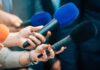 Fire Erupts Above Getty—Traffic Melts Down Reporters holding colorful microphones