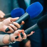 Superman Bot Hype Fuels China Cash Grab Reporters holding colorful microphones