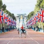 Budget Crunch Looms—War Shock Triggers UK Panic mounted guard on white horse along flag-lined boulevard