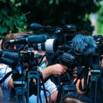 Tantrum Kid Grounds Plane — Chaos Follows TV news cameras crowding together at an outdoor event