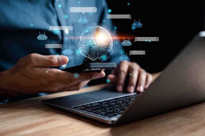 shutterstock_2249571297-1 Person using smartphone and laptop with AI hologram