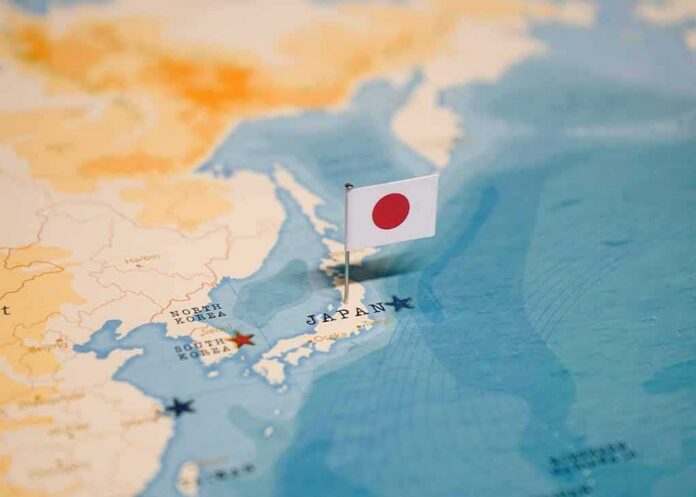 Japanese flag pin marking Japan on a world map