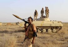 Guided Rockets via AI? Alarming Try Soldier with RPG launcher walking past armored vehicle with troops