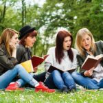 DA’s Picnic Meets Fentanyl Reality Group of young women reading books on grass in a park