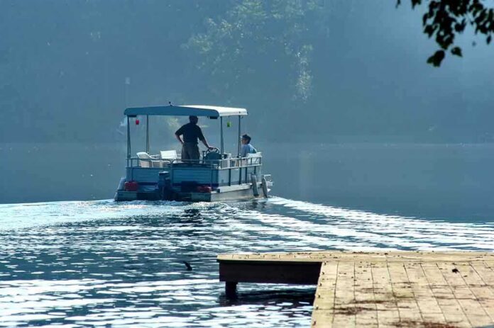 shutterstock_507843 Two people on a boat navigating a misty lake