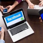 Facebook Death Threat Sparks SWAT Takedown Laptop with Facebook on screen surrounded by smartphones