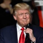 RNC Humiliation: Underwear Pic Hijacks Stage man in suit holding a microphone