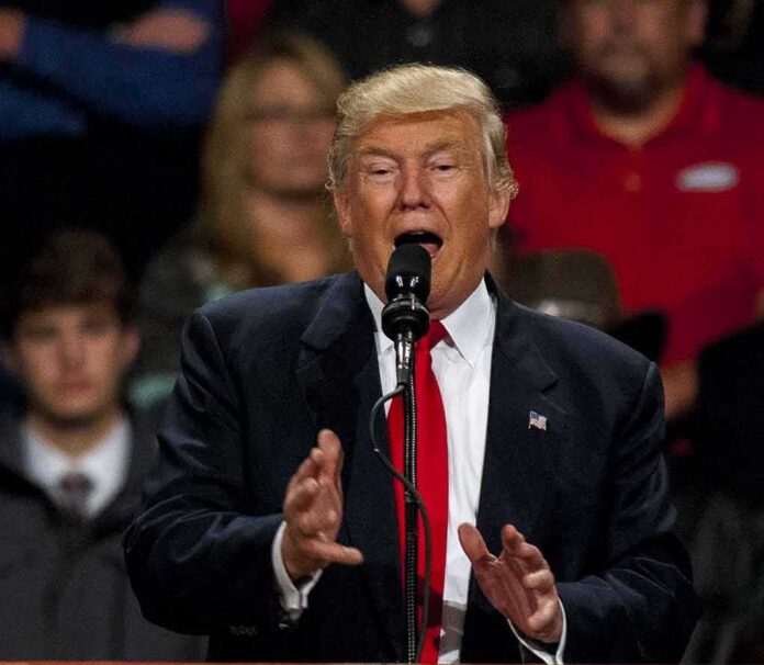 Donald Trump speaking at a podium with a microphone