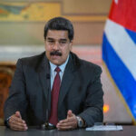Nicolás Maduro speaking at a podium with a microphone
