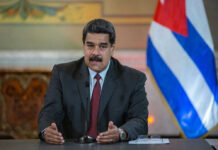 DOJ Indicts Maduro For Torturing Americans Nicolás Maduro speaking at a podium with a microphone