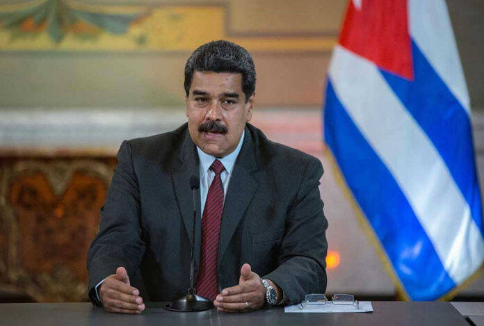 1102291202 Nicolás Maduro speaking at a podium with a microphone