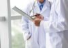 Doctor Access COLLAPSES Under Obamacare Doctors reviewing a clipboard