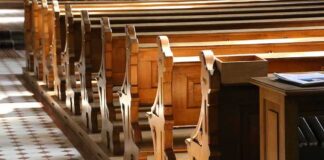 wooden church pews in sunlight