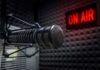 Campus Firestorm After Lillard’s Jaw-Dropping Claim Close-up of a studio microphone with an illuminated on-air sign