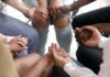 Group holding hands in a supportive circle