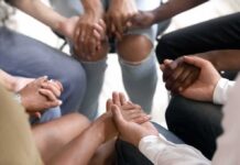 Group holding hands in a supportive circle