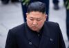 Kim Jong-chang in a black overcoat looking to the side