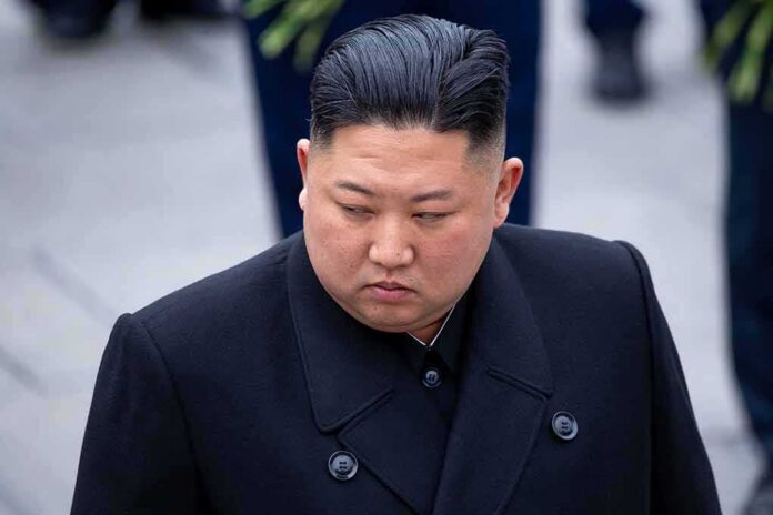 Kim Jong-chang in a black overcoat looking to the side