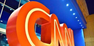 Large red CNN logo sculpture at building entrance