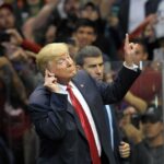 Trump Rally Line Explodes Backlash Donald Trump gestures with one hand raised at a crowded event