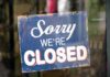 Paris on Edge: Louvre Shuts Down Hanging closed sign on a shop door