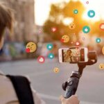 ASU Monetizes Hype – Degree in Influencing Person livestreaming with smartphone on gimbal outdoors