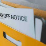 Mass Layoffs Hit Springfield – Blame Game Explodes layoff notice in a yellow file holder