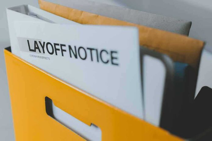 layoff notice in a yellow file holder