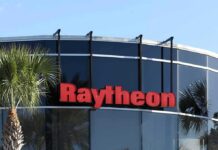 Raytheon Scores Big – What’s Washington Betting? Raytheon logo on a modern glass office building