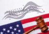 Gavel on U.S. flag beside official election mail envelope