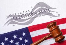 DOJ Slams California Over ‘Likely’ Voters Gavel on U.S. flag beside official election mail envelope