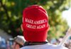 MAGA Trap Springs – Rogers Won’t Bite person wearing a red baseball cap at an outdoor gathering