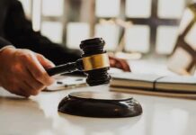 Immigration Clash: DOJ Moves to Muzzle Bench Judge's gavel striking sound block on a desk