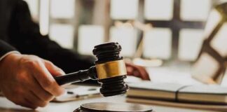 Judge's gavel striking sound block on a desk