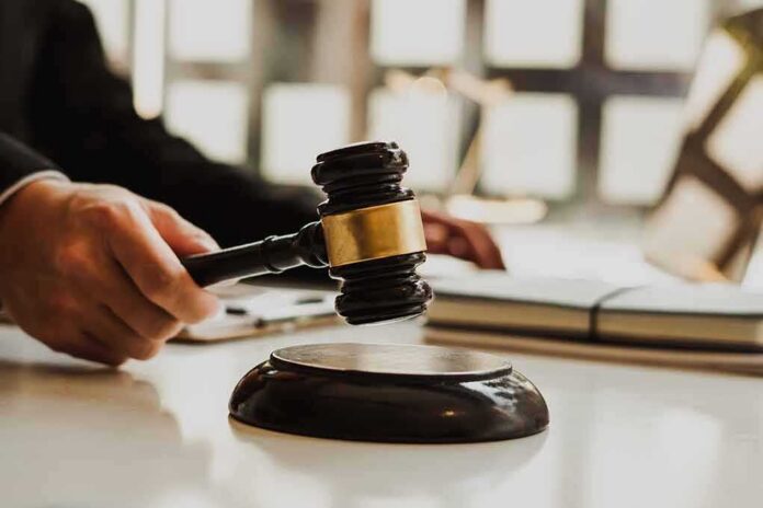 Judge's gavel striking sound block on a desk