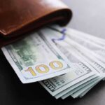 Gallego’s Power Play: Middle Class Fix – or Job Killer? Wallet with US hundred-dollar bills fanned out