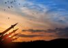 Silhouette of missile launchers at sunset