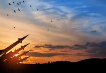 Silhouette of missile launchers at sunset