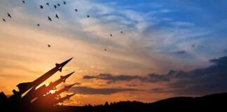 Silhouette of missile launchers at sunset