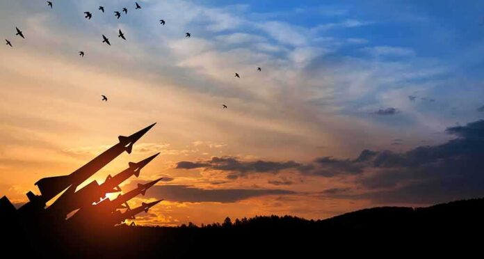 Silhouette of missile launchers at sunset