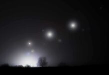 Congress Eyes Mysterious Orb ‘Mothership’ Night sky over a silhouetted landscape with glowing orbs of light