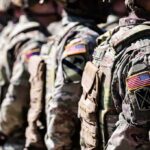 Pentagon Pay Shock – What’s Driving It? Soldiers in camouflage uniforms standing in formation