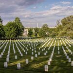 Deadline Blown – OC Cemetery Stalled Again Rows of white headstones in a cemetery under a partly cloudy sky