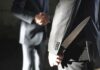 Federal Overreach CRUSHED – Knives Reclassified man in suit hides a knife behind his back while shaking hands